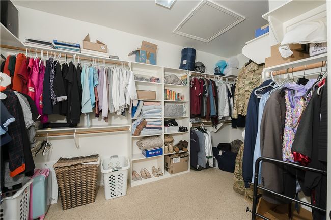 Spacious closet featuring attic access and carpet flooring | Image 21