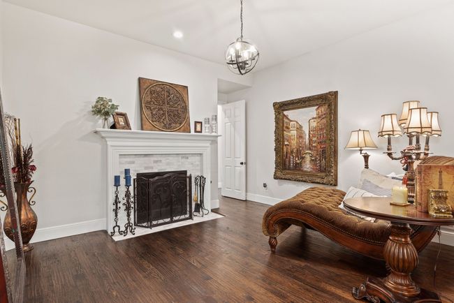The sitting room includes a fireplace. | Image 18