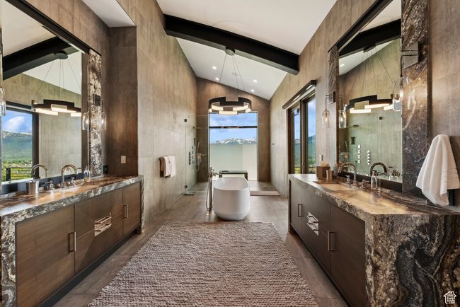 Full bathroom with two vanities, a freestanding tub, beam ceiling, tile walls, and recessed lighting | Image 30