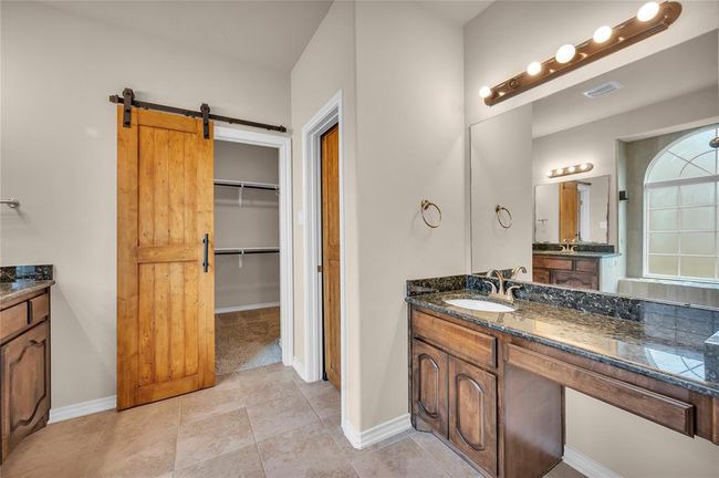 Charming sliding barn doors enhance the home's character. | Image 24