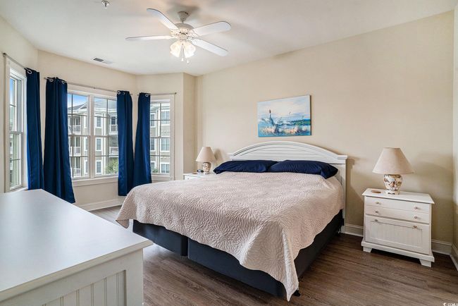 Bedroom featuring dark wood-style floors, baseboards, and a ceiling fan | Image 8
