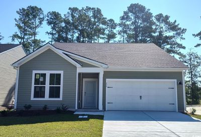 View of front of home with a garage and a front lawn | Image 1