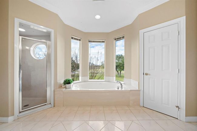 The luxurious bath invites relaxation with its own vantage point of the tranquil outdoors. | Image 25