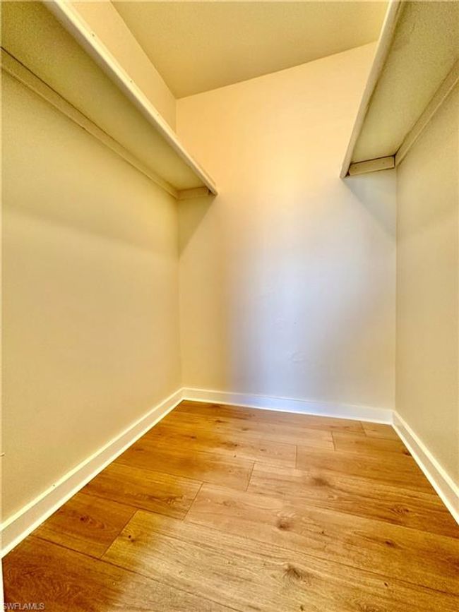 Walk in closet with hardwood / wood-style floors | Image 13