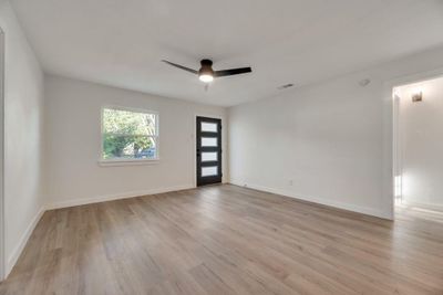 Unfurnished room featuring ceiling fan and light hardwood / wood-style floors | Image 3