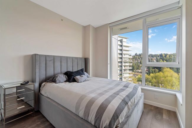 Bedroom featuring visible vents, dark wood-style flooring, and baseboards | Image 16