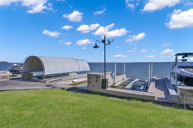 The property includes a boat slip with electric boat lift and partial silp suitable for a jet ski. | Image 26