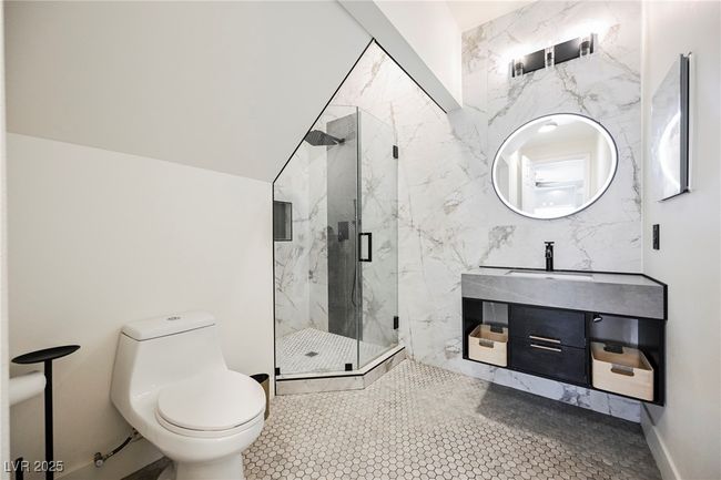 En Suite Full Bath with toilet, a marble finish shower, and vanity | Image 32