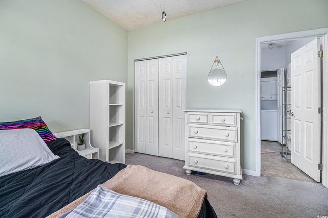 Bedroom featuring carpet, a closet, and en-suite bathroom. | Image 10