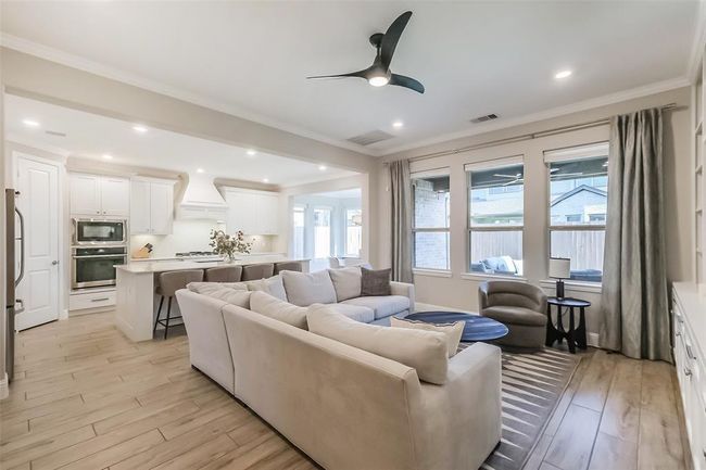 The kitchen in the main residence is spacious, bright and open. Notice the oversized kitchen island with commercial style pull-down faucet. | Image 6