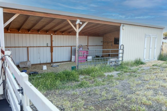 View of outdoor stables with water and power / storage room. | Image 101