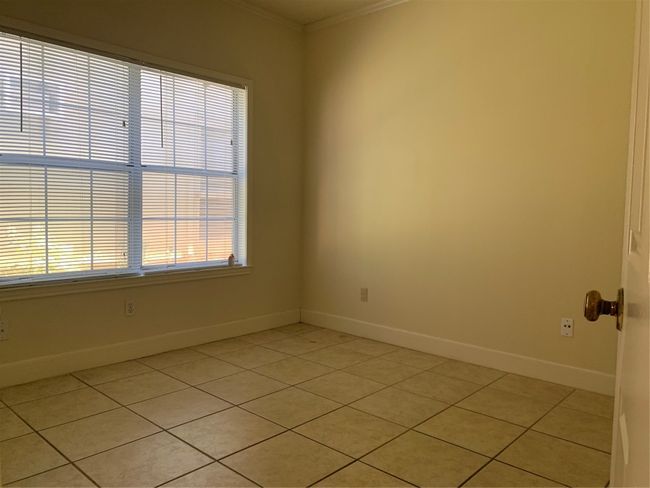 Empty room with baseboards, ornamental molding, and light tile patterned flooring | Image 5