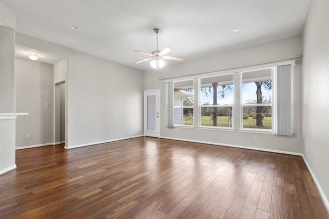 Unfurnished room featuring a ceiling fan, dark wood-type flooring, and recessed lighting | Image 9