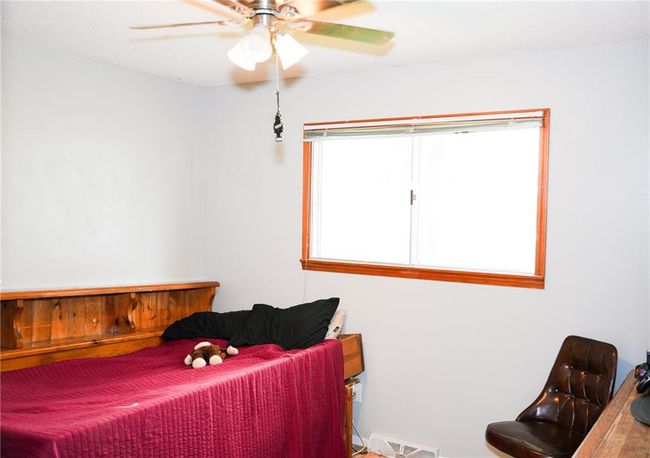 Bedroom with visible vents and a ceiling fan | Image 16