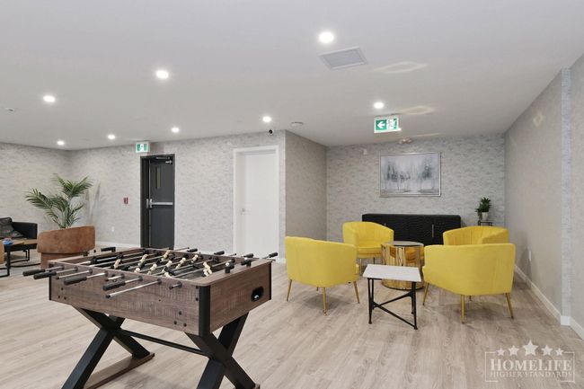 Game room with wallpapered walls, wood finished floors, visible vents, and recessed lighting | Image 25