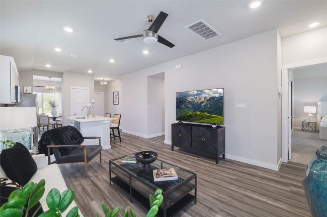 Living room with wood finished floors, a ceiling fan and recessed lighting | Image 8