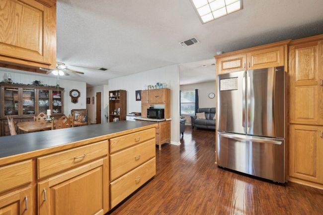 Kitchen featuring dark wood-style flooring, freestanding refrigerator, visible vents, and ceiling​​‌​​​​‌​​‌‌​‌‌​​​‌‌​​‌‌​‌​​​​​‌ fan | Image 14