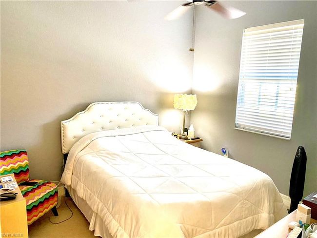 Bedroom with ceiling fan and carpet | Image 15