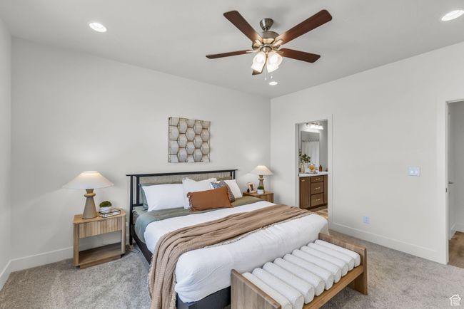 Carpeted bedroom with ceiling fan and ensuite bathroom | Image 17