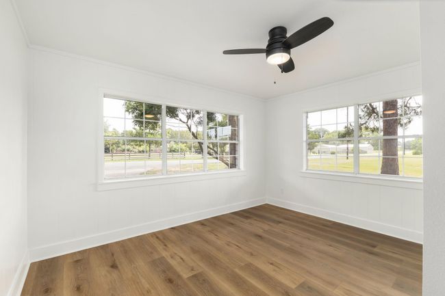 Bright front bedroom with large windows, serene views, and elegant flooring. | Image 29