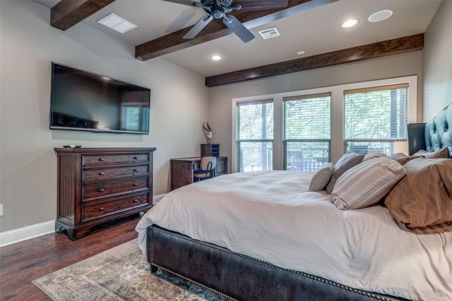 Bedroom with beamed ceiling, dark hardwood / wood-style floors, and ceiling fan | Image 11