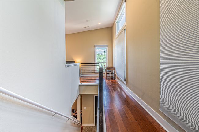 Hallway with an upstairs landing and wood finished floors | Image 16
