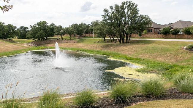 View of property's community with a water view and a lawn | Image 11