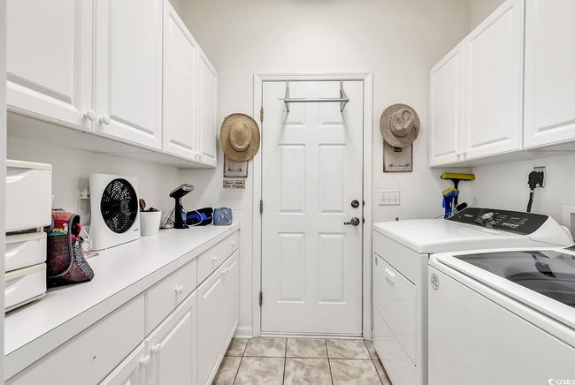 Laundry area with cabinet space and washing machine and clothes dryer | Image 12