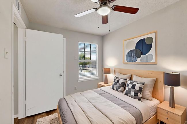 Bedroom with a textured ceiling, wood finished floors, and ceiling fan | Image 20