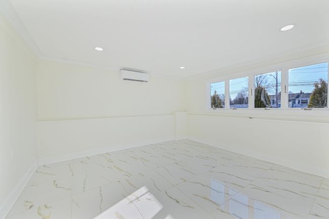 Empty room with crown molding and an AC wall unit | Image 38