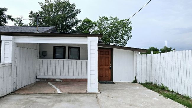 View of outdoor structure with a porch and fence | Image 34