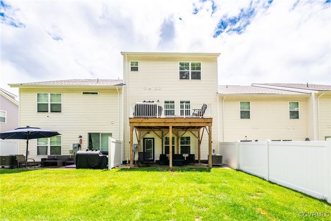 Back of house with an outdoor hangout area, a patio, a fenced backyard, and a deck | Image 40