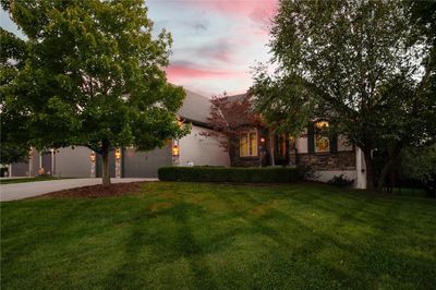 Obstructed view of property with a garage and a lawn | Image 3