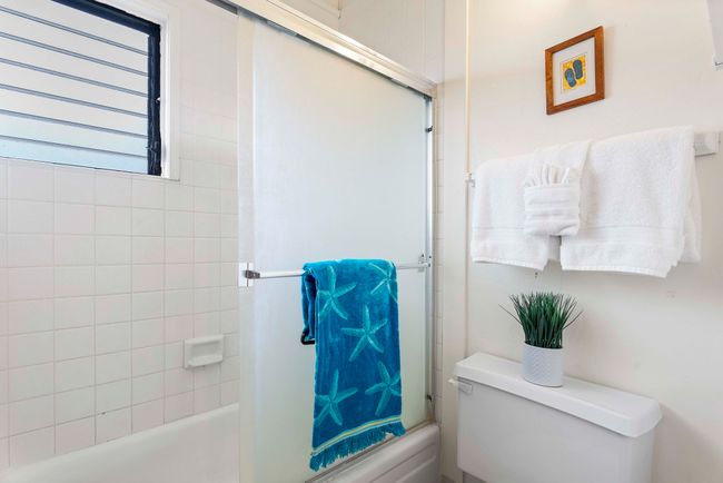 Convenient tub/shower area is separated with a pocket door for added privacy | Image 16