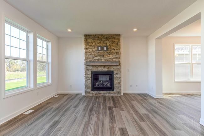 Photo is of the actual home. The spacious family gathering area seamlessly connects to the kitchen area, perfect for entertaining. It also features many large windows providing warm natural light. | Image 5
