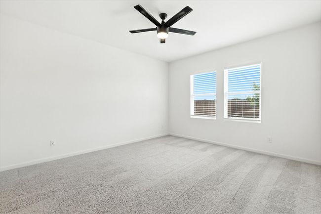 Carpeted spare room featuring baseboards and ceiling fan | Image 16