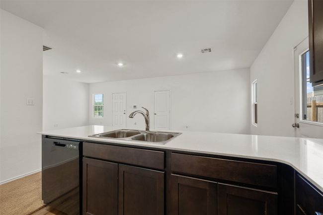 Kitchen featuring dishwasher, dark brown cabinetry, light countertops, and recessed lighting | Image 21