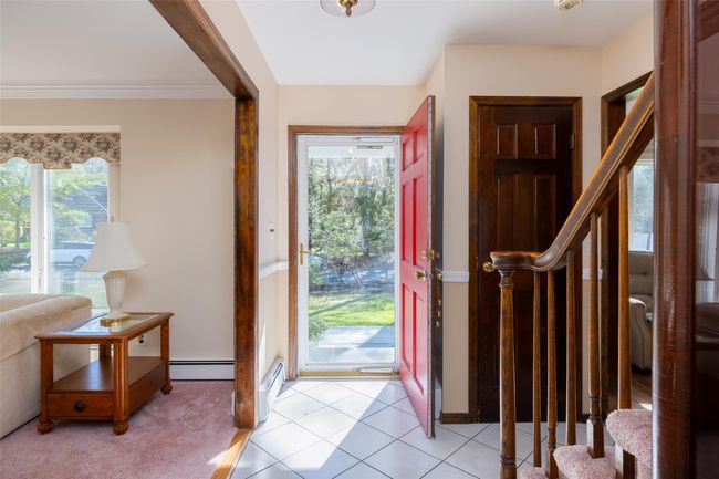 Foyer with stairway, ornamental molding, and baseboard heating | Image 4