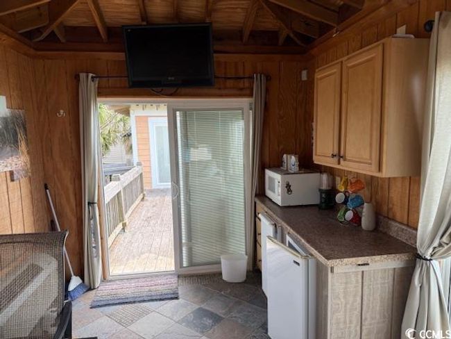 Doorway to outside with wood walls and beam ceiling | Image 17