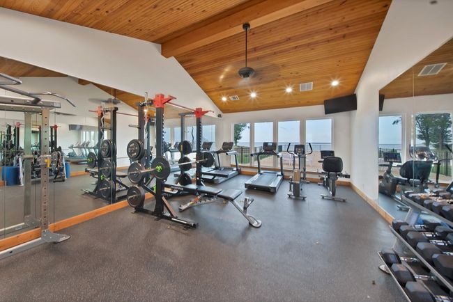 Workout area featuring wooden ceiling | Image 15