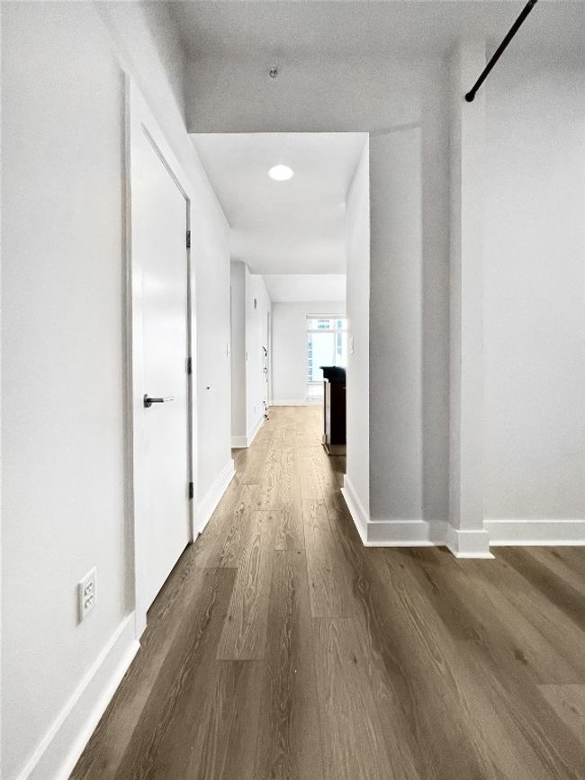 Hallway with wood finished floors and baseboards | Image 6