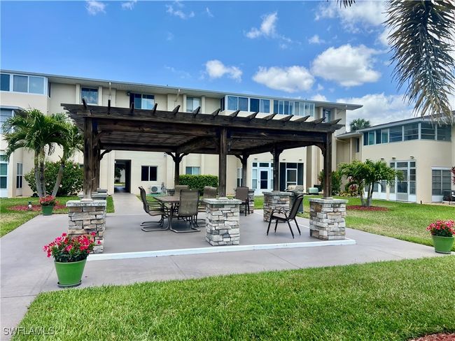 View of community featuring a pergola, a patio area, and a lawn | Image 23