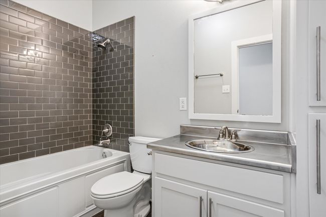 Full bathroom featuring vanity, toilet, and tiled shower / bath | Image 18