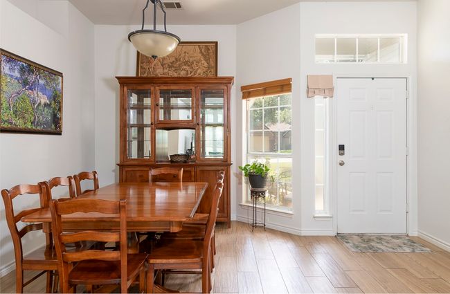Dining room with baseboards and light wood finished floors | Image 5