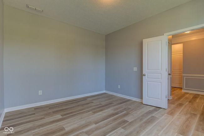 unfurnished room with light wood-style flooring and a textured ceiling | Image 17