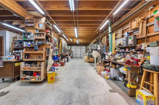 Garage with a workshop area | Image 42