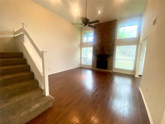 Living room with high ceiling, a ceiling fan | Image 4