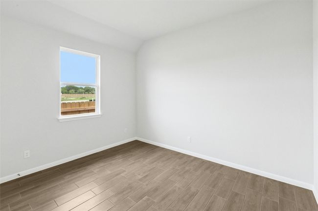 Empty room with wood finished floors and baseboards | Image 14