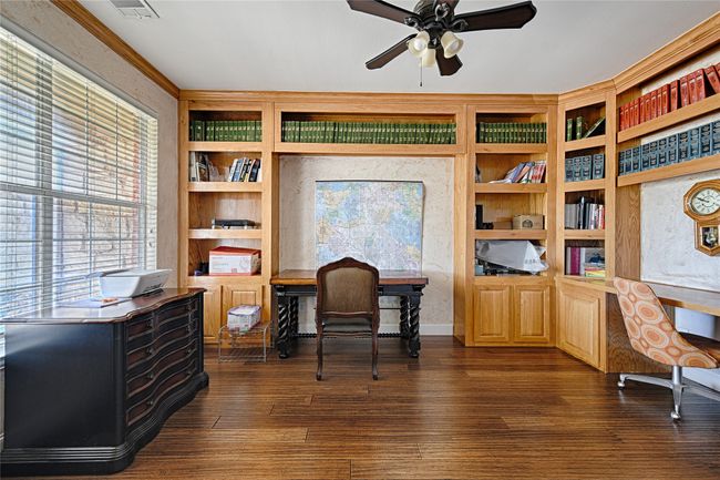 Home office with visible vents, built in features, ceiling fan, dark wood-style flooring, and built in desk | Image 5