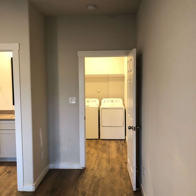 Laundry room featuring separate washer and dryer, dark wood-style floors, and baseboards | Image 20